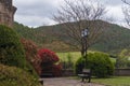 Beautiful shot of a garden, benches, street lamps, and hills