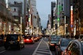 Beautiful shot of Ginza cars and buildings with neon signs in Tokyo, Japan