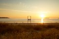 Beautiful shot of a golden sunset over the sea with the beach lifeguard chair in the middle Royalty Free Stock Photo