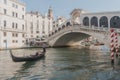 Beautiful shot of a gondola sailing under the Rialto Bridge in Venice, Italy Royalty Free Stock Photo