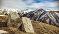 Beautiful shot of gravestones near snowy mountains and cliffs