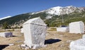 Beautiful shot of gravestones near snowy mountains and cliffs