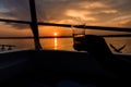 Beautiful Shot Of A Hand Silhouette Holding A Shot Glass On A Boat With A Sunset Background