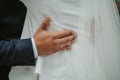 Beautiful shot of the hands of a groom wearing a ring and holding the back of the bride - wedding Royalty Free Stock Photo