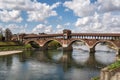 Beautiful shot of the historic Ponte Coperto Bridge over the Ticino river in Pavia, Lombardy, Italy Royalty Free Stock Photo