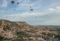 Beautiful shot of the hot air balloons over a landscape in the Cappadocia area in Turkey Royalty Free Stock Photo