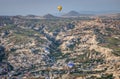 Beautiful shot of the hot air balloons over a landscape in the Cappadocia area in Turkey Royalty Free Stock Photo