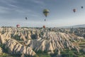 Beautiful shot of the hot air balloons over a landscape in the Cappadocia area in Turkey Royalty Free Stock Photo