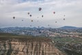 Beautiful shot of the hot air balloons over a landscape in the Cappadocia area in Turkey Royalty Free Stock Photo