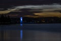 Beautiful shot of the illuminated lighthouse near the shore in Sylvan Lake in Alberta, Canada