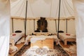 Beautiful shot of the interior of a rustic-style tent with beds for luxury camping