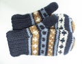 Beautiful shot of knitted wool gloves with striped patterned with white background