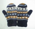 Beautiful shot of knitted wool gloves with striped patterned with white background