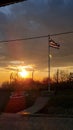 Beautiful shot of a landscape under the sunset and a flag near