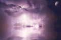 Beautiful shot of lightning striking the ocean with purple clouds and a visible moon in the sky Royalty Free Stock Photo