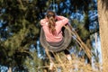 Beautiful shot of a little girl playing on a tire swing Royalty Free Stock Photo