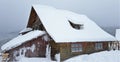 Beautiful shot of a log house covered with snow on a cold winter day in the forest Royalty Free Stock Photo