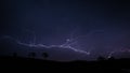 Beautiful shot of a long lightning bold in a dark purple sky Royalty Free Stock Photo