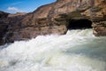 Beautiful shot of lumps of water pouring from the inside of a cave in a stone rock Royalty Free Stock Photo