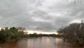 Beautiful shot of Luvuvhu river in flood with autumn trees and cloudy sky at sunset