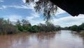 Beautiful shot of Luvuvhu river in flood with trees and blue cloudy sky in Limpopo province, Africa