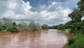 Beautiful shot of Luvuvhu river in flood with trees and blue cloudy sky in Limpopo province, Africa