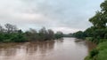 Beautiful shot of Luvuvhu river in flood with trees and cloudy sky in Limpopo province, Africa
