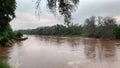 Beautiful shot of Luvuvhu river in flood with trees and cloudy sky in Limpopo province, Africa