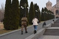 Beautiful shot of the male and female walking on the pavement of Saint Grigor Lusavorich Church