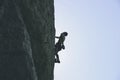 Beautiful shot of a male rock climbing with a clear sky in the background