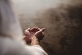 Beautiful shot of a male wearing a biblical robe holding water with his palms