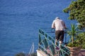 Beautiful shot of a man looking from a balcony at the sea in Capri Island, Italy Royalty Free Stock Photo