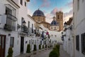 Beautiful shot of a manless street of white houses with the view of a church in Altea Alicante Spain