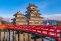 Beautiful shot of Matsumoto castle and its famous red bridge under a clear blue sky Royalty Free Stock Photo