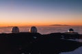 Beautiful shot of the Mauna Kea Observatories on a seaside at sunset Royalty Free Stock Photo