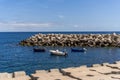 Beautiful shot of motor boats by a concrete breakwater in Madeira, Portugal