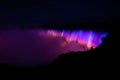 Beautiful shot of Niagara falls with colorful neon lights at night Royalty Free Stock Photo