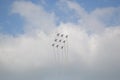 Beautiful shot of nine warplanes in the sky going in the same direction.