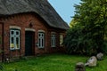 Beautiful shot of an old brick house with a cute green lawn in the front Royalty Free Stock Photo