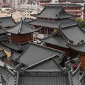 Beautiful shot of an old Buddhist temple rooftop against skyscrapers of Shanghai, China Royalty Free Stock Photo