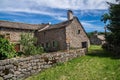 Beautiful shot of old stone houses and green trees in La Fage-Saint-Julien, Lozere, France