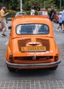 Beautiful shot of an orange retro car from behind in Fiat-Fico Fest 2022 in Sarajevo