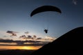 Beautiful shot of a paraglider silhouette flying over Monte Cucco Umbria, Italy and toward the sunset, with beautiful Royalty Free Stock Photo