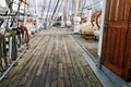 Beautiful shot of the part of a ship deck with a wooden floor and ropes and cables around the area