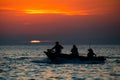 Beautiful shot of a people boat in the sea in the sunset