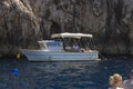 Beautiful shot of people on a cruising yacht on Capri Island in Naples, Italy Royalty Free Stock Photo