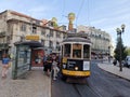 Beautiful shot of people trying to get on the famous tram in the streets of Lisbon