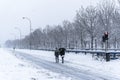 Beautiful shot of people walking in the empty snowy streets in Madrid, Spain in 2021 Royalty Free Stock Photo