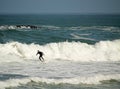 Beautiful shot of a person doing waves ride sport on board with black suit