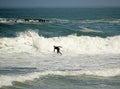 Beautiful shot of a person doing waves ride sport on board with black suit